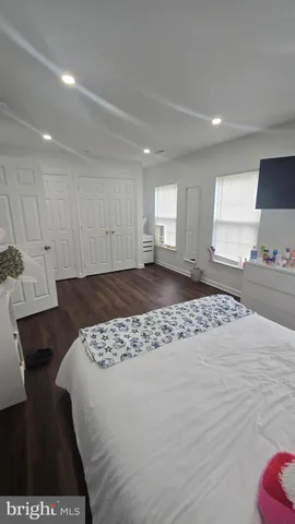 a living room with lots of furniture and a wooden floor