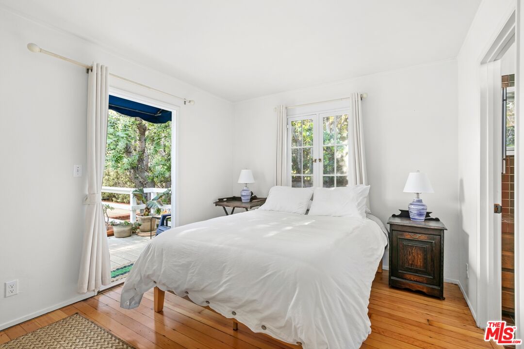 30800 Broad Beach Road Malibu, CA 90265 - Photo 27 of 28 a bedroom with a bed and wooden floor