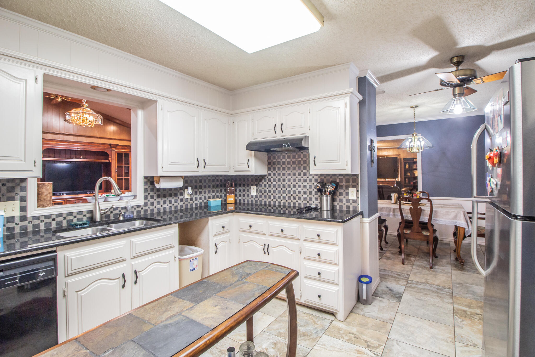 4213 88th Place Lubbock, TX 79423 - Photo 11 of 40 a kitchen with white cabinets and sink