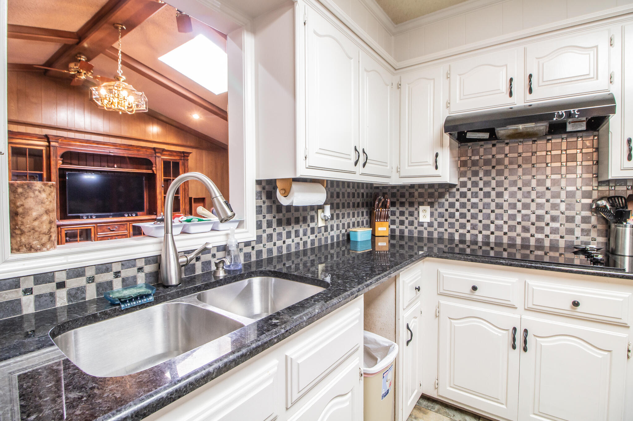 4213 88th Place Lubbock, TX 79423 - Photo 12 of 40 a kitchen with granite countertop a sink a stove and cabinets