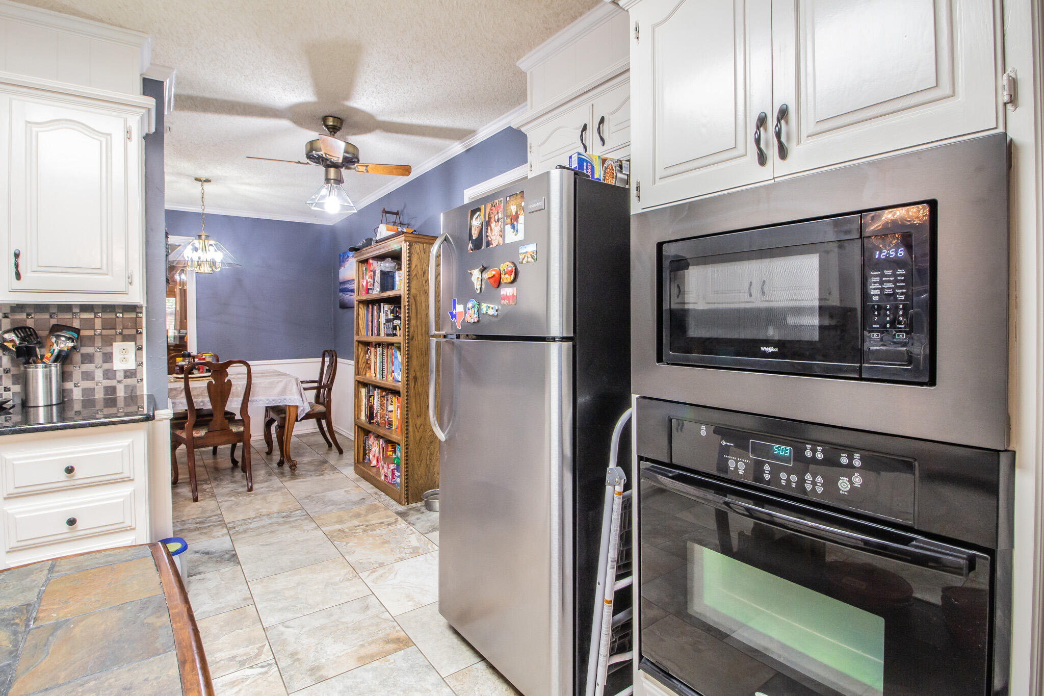 4213 88th Place Lubbock, TX 79423 - Photo 13 of 40 a kitchen with stainless steel appliances granite countertop a refrigerator and a stove