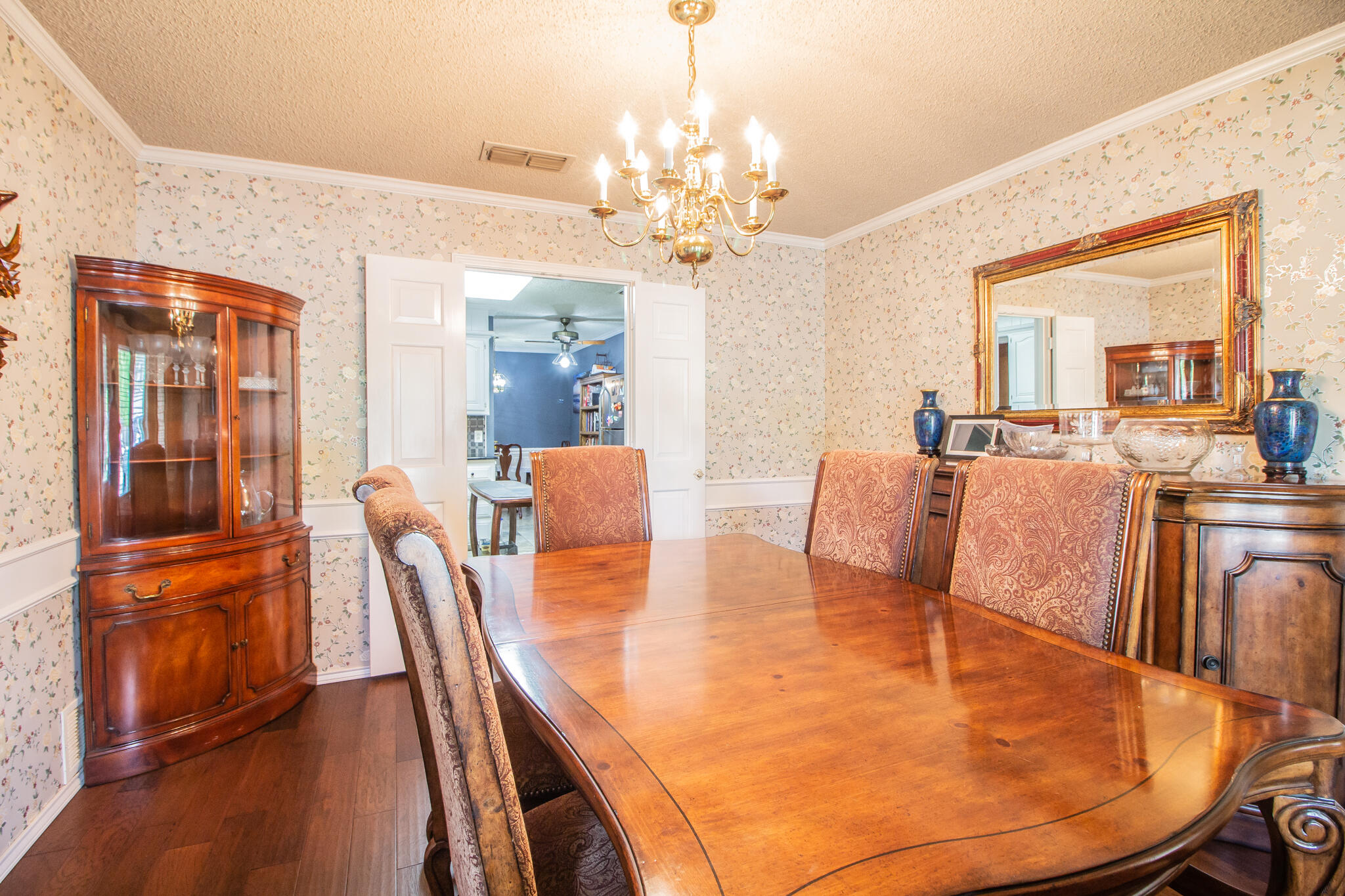 4213 88th Place Lubbock, TX 79423 - Photo 17 of 40 a living room with dining room and wooden floor