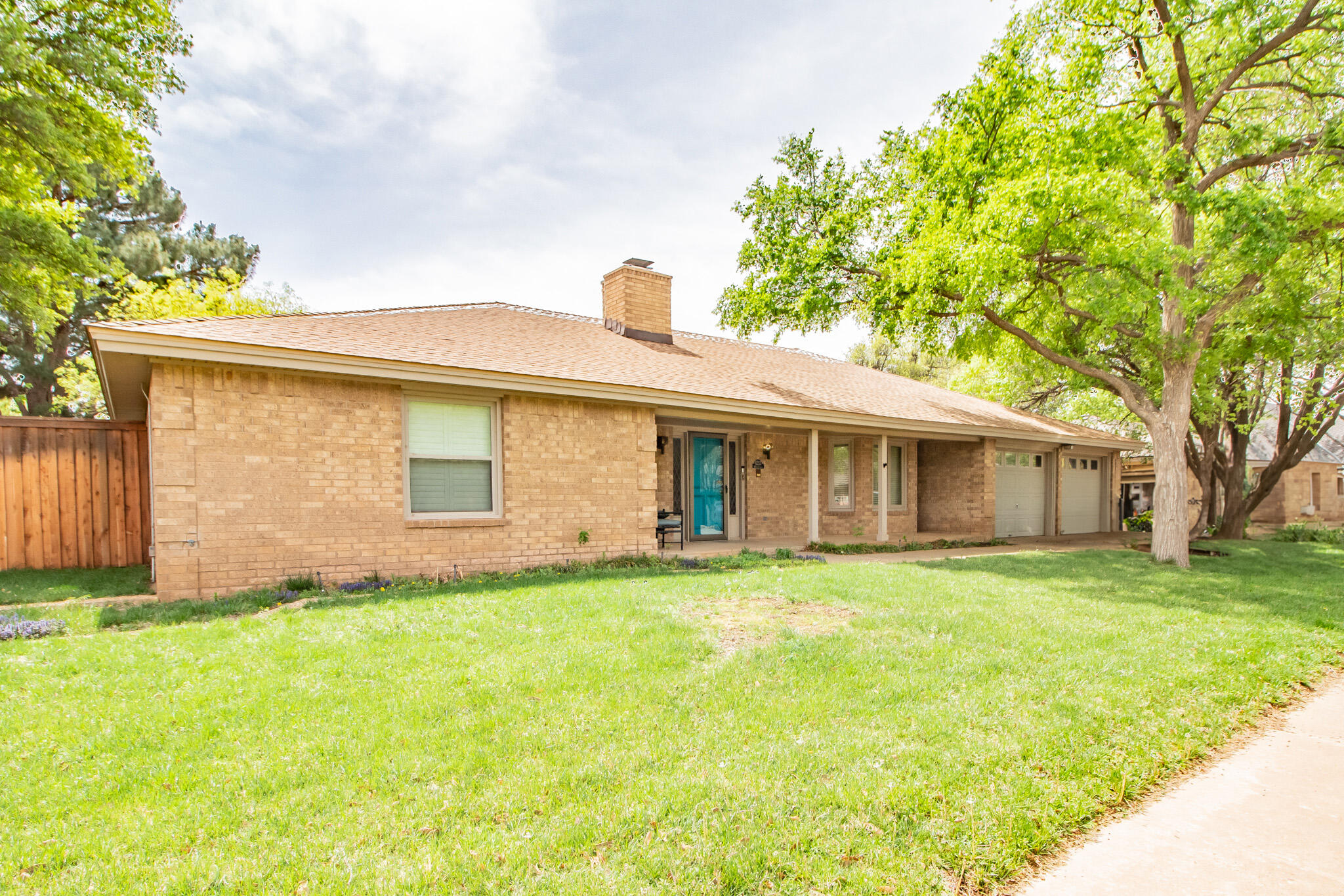 4213 88th Place Lubbock, TX 79423 - Photo 2 of 40 a front view of house with yard and trees
