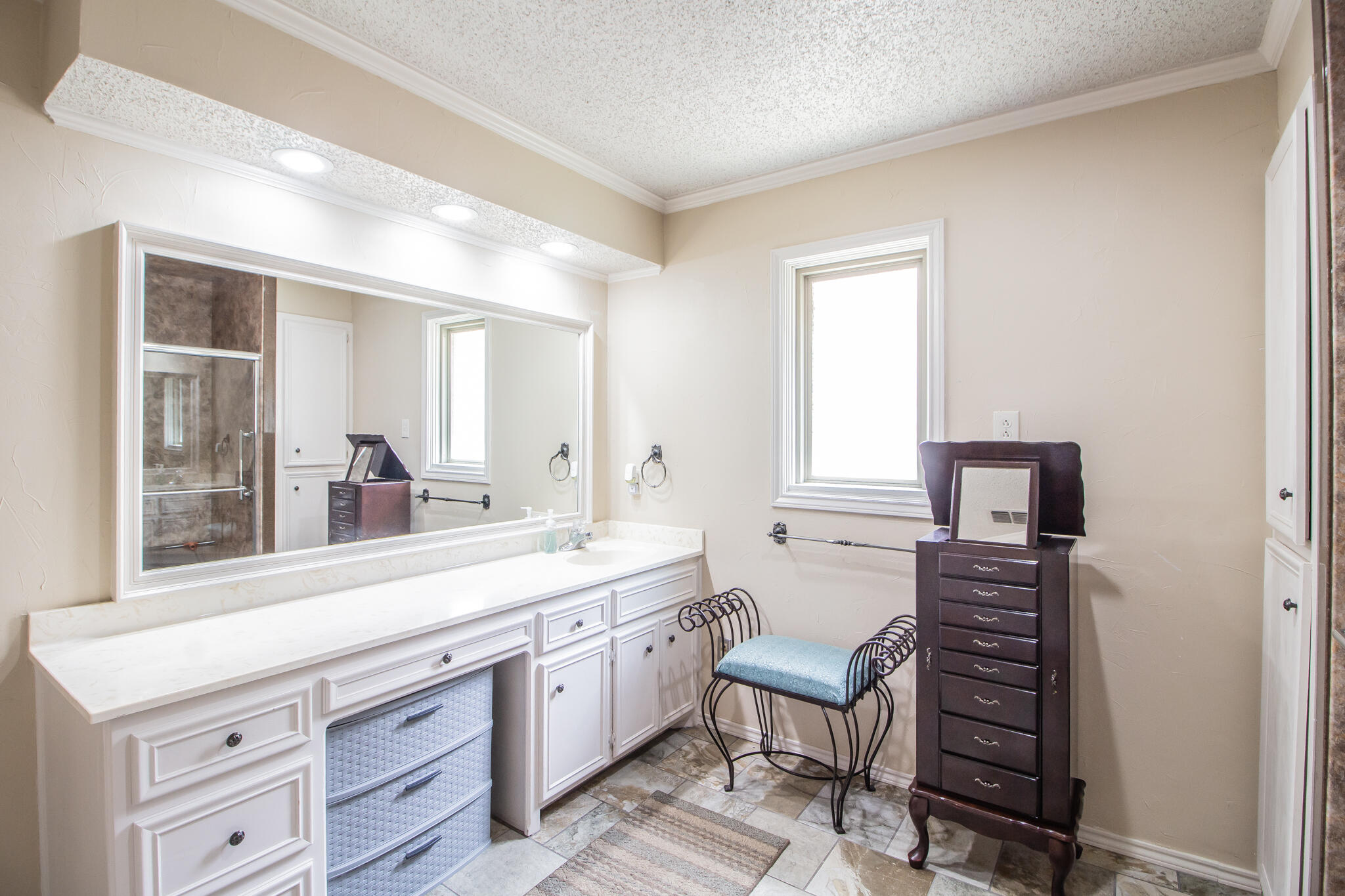 4213 88th Place Lubbock, TX 79423 - Photo 26 of 40 a spacious bathroom with a double vanity sink and a mirror