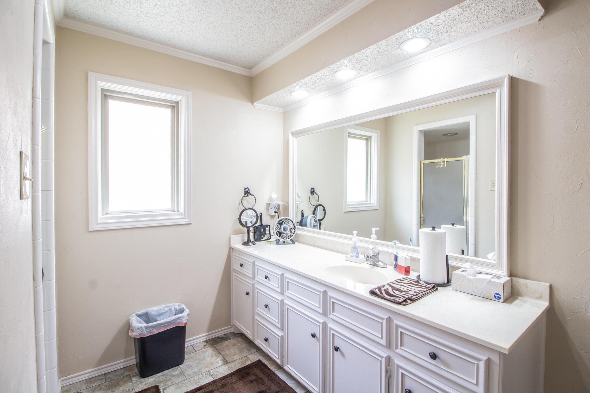 4213 88th Place Lubbock, TX 79423 - Photo 27 of 40 a bathroom with a sink and a mirror