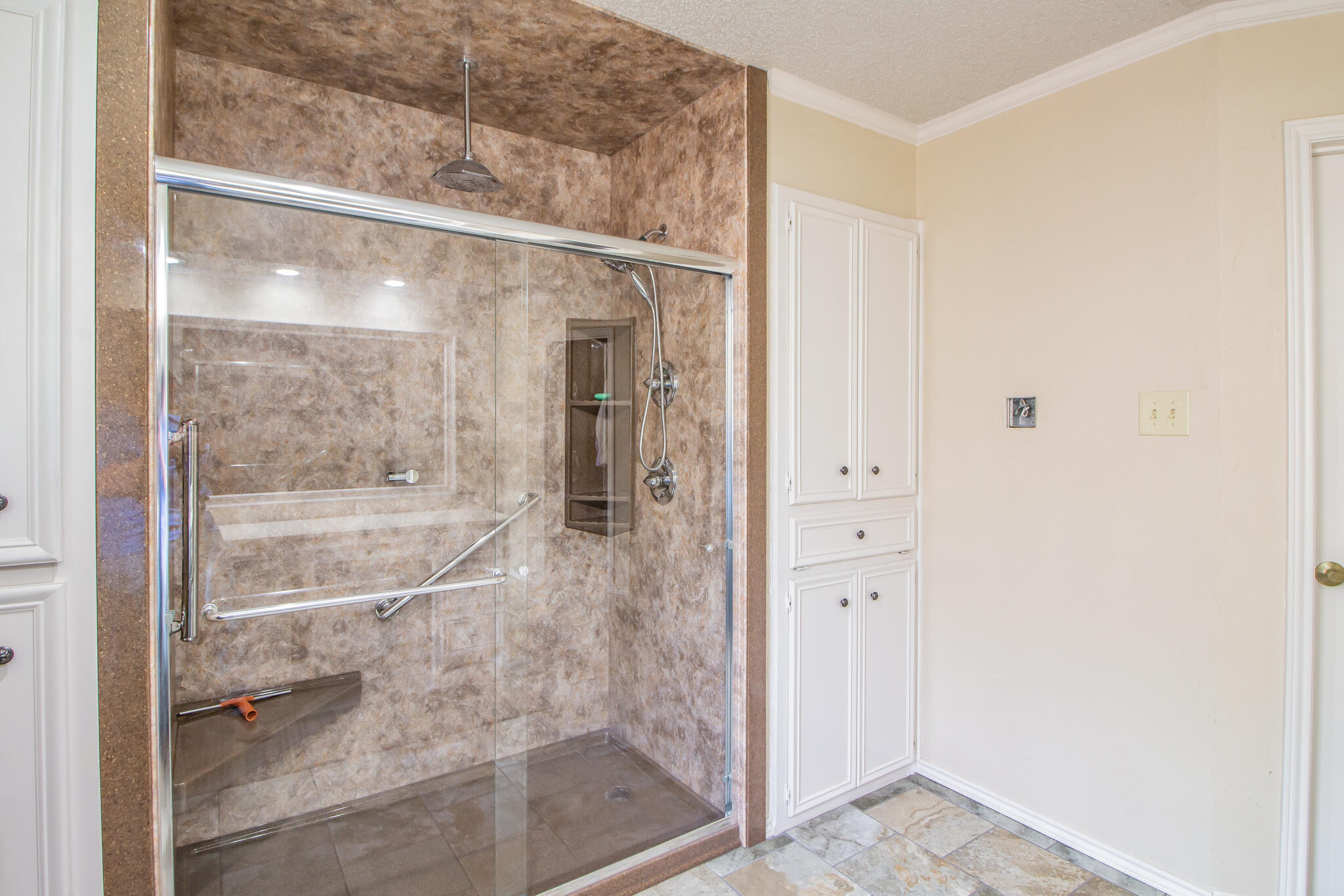 4213 88th Place Lubbock, TX 79423 - Photo 28 of 40 a bathroom with a glass shower door