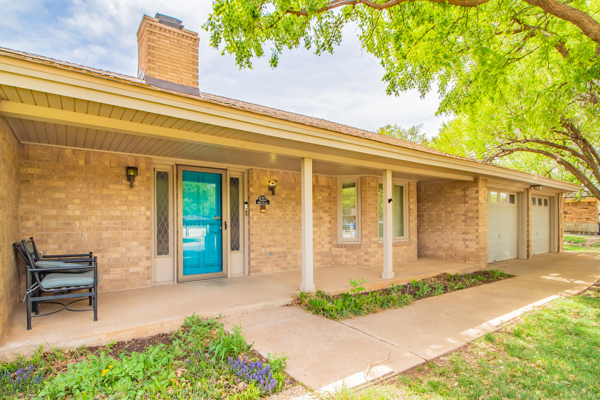4213 88th Place Lubbock, TX 79423 - Photo 3 of 40 a front view of a house with a garden and outdoor seating