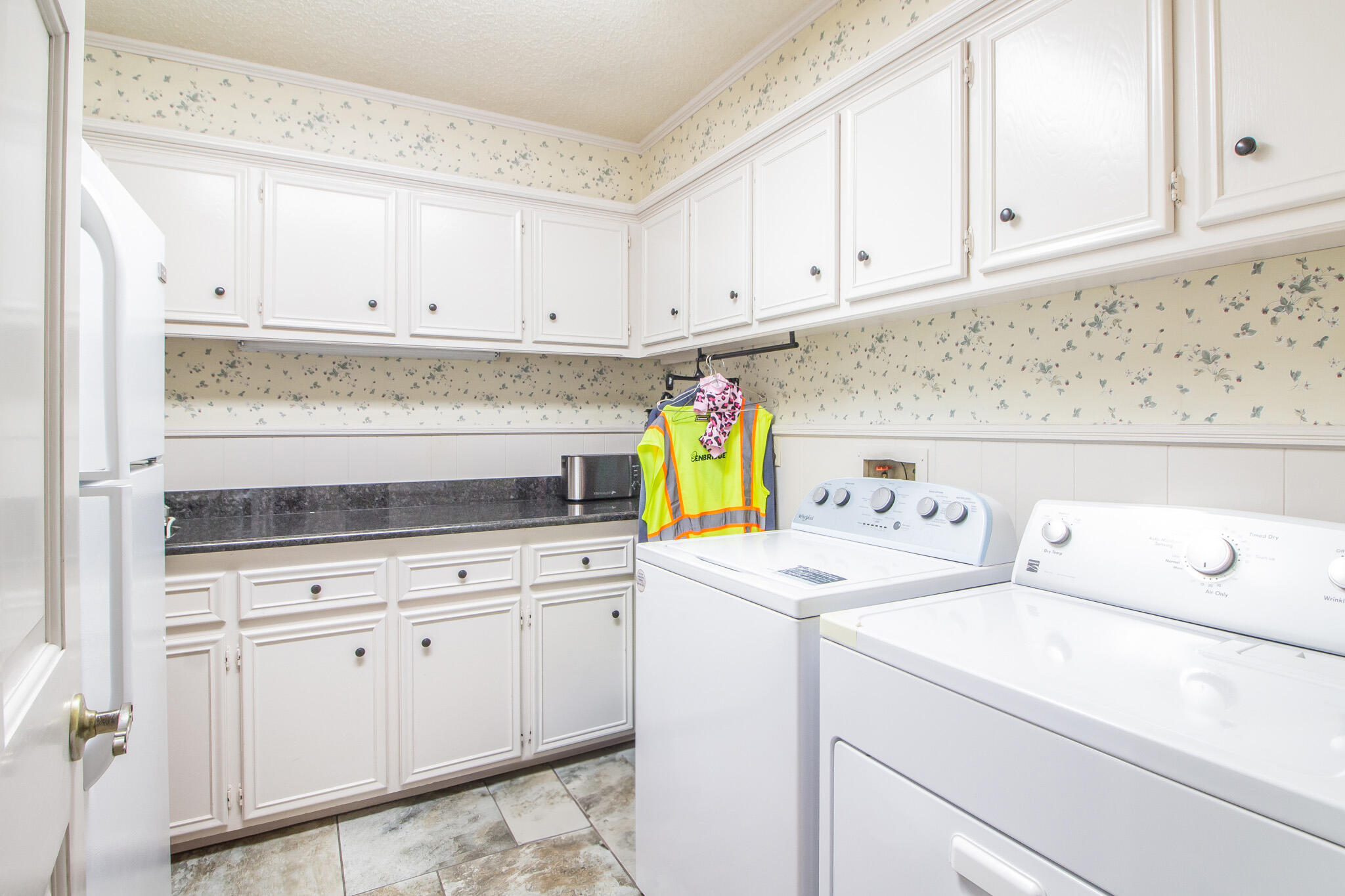 4213 88th Place Lubbock, TX 79423 - Photo 34 of 40 a utility room with cabinets washer and dryer