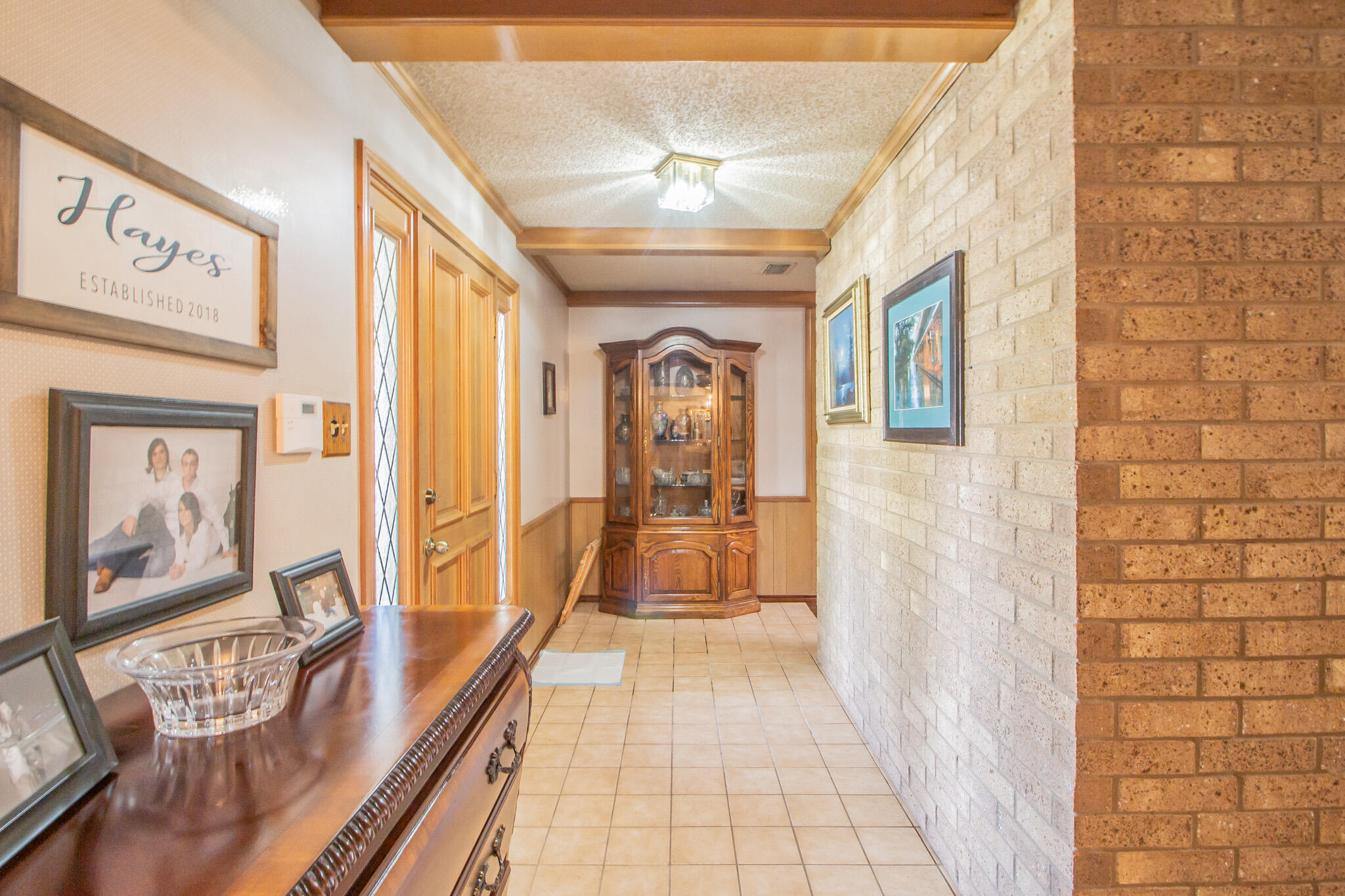 4213 88th Place Lubbock, TX 79423 - Photo 5 of 40 a view of a hallway with wooden floor and furniture