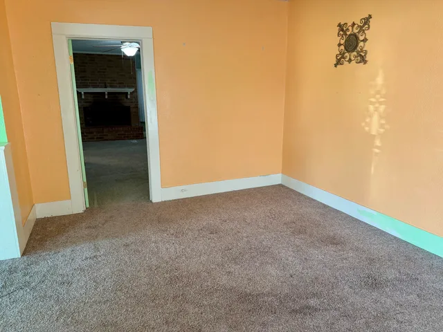 a view of an empty room and a bathroom