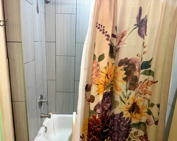 a bathroom with a shower and a tub