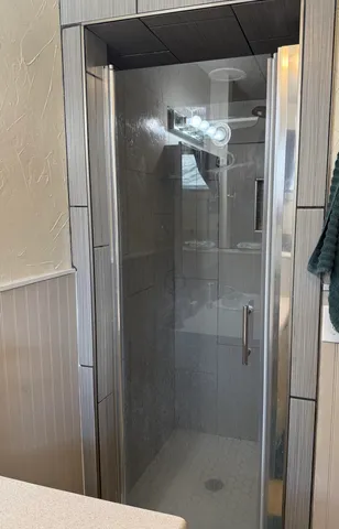 a bathroom with a glass shower door