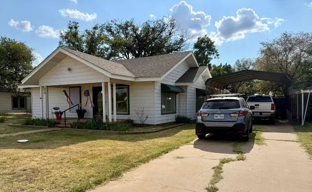 a view of a car parked in front of a house