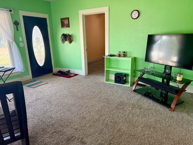 a living room with fireplace furniture and a flat screen tv