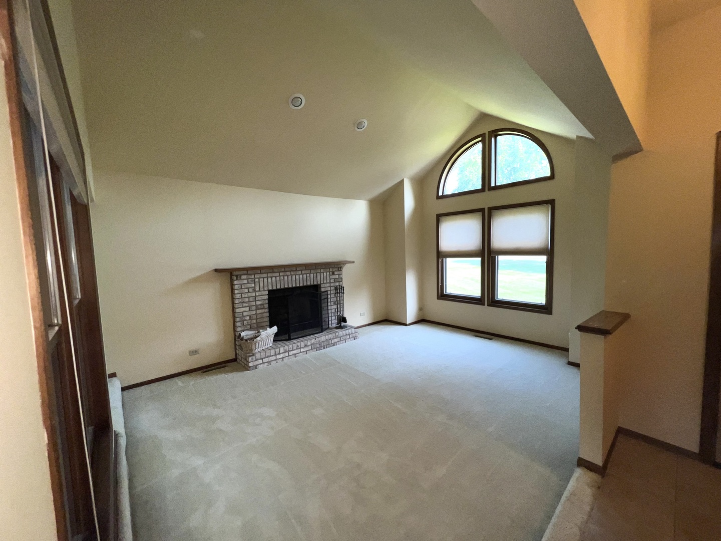 39-w139 Adobe Ridge Elgin, IL 60124 - Photo 4 of 26 an empty room with windows fireplace and a ceiling fan