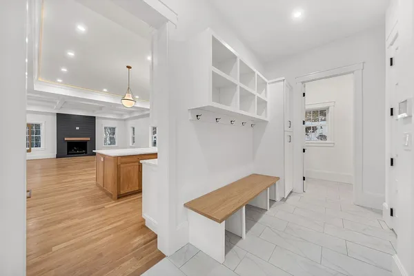 a large kitchen with stainless steel appliances kitchen island granite countertop a stove a sink and white cabinets