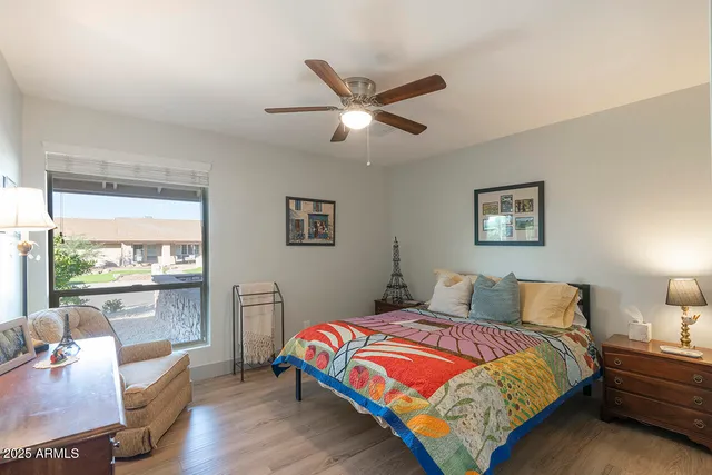 a bedroom with a large bed and a chandelier