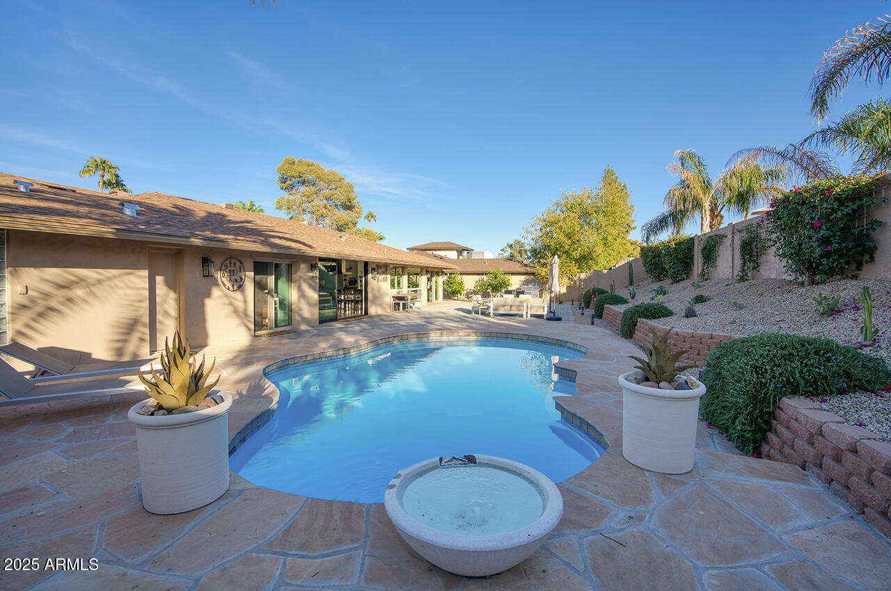 3337 East Las Rocas Drive Phoenix, AZ 85028 - Photo 20 of 22 a view of a swimming pool with potted plants