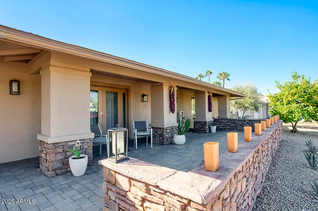 a view of a patio with dining table and chairs potted plants