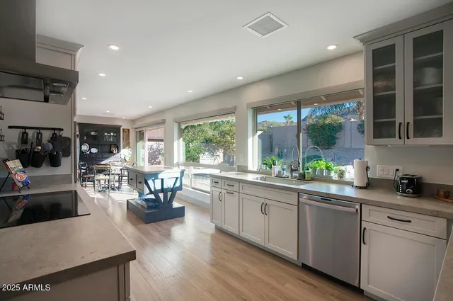 a kitchen with sink stove and cabinets