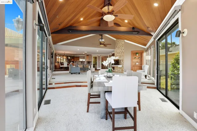 a view of a dining room with furniture wooden floor and chandelier