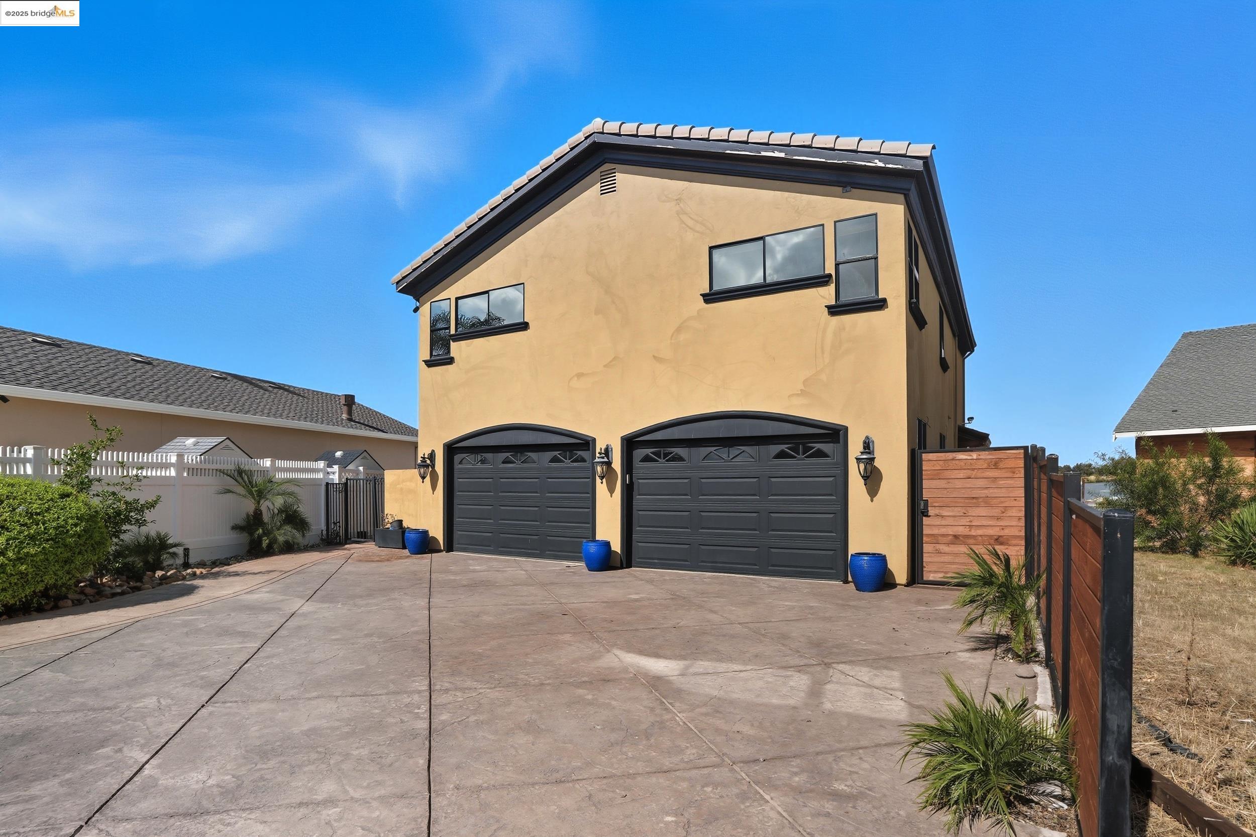4814 S Point Discovery Bay, CA 94505 - Photo 2 of 52 a front view of a house with a yard and garage