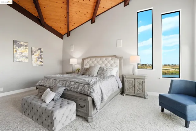 a bedroom with a bed and a couch with window