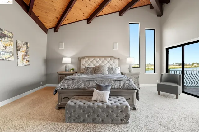 a bedroom with a bed and glass window