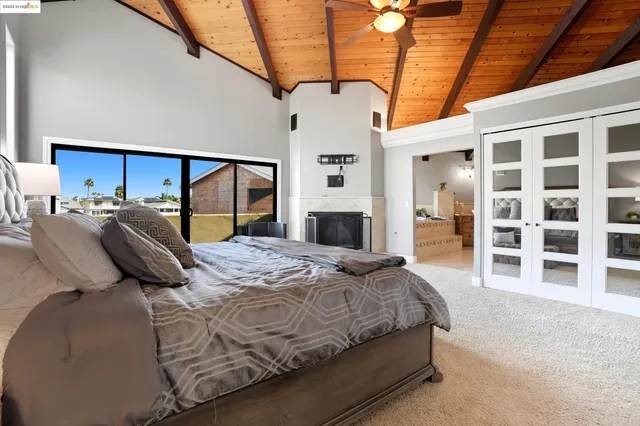 a bedroom with a bed and a large window