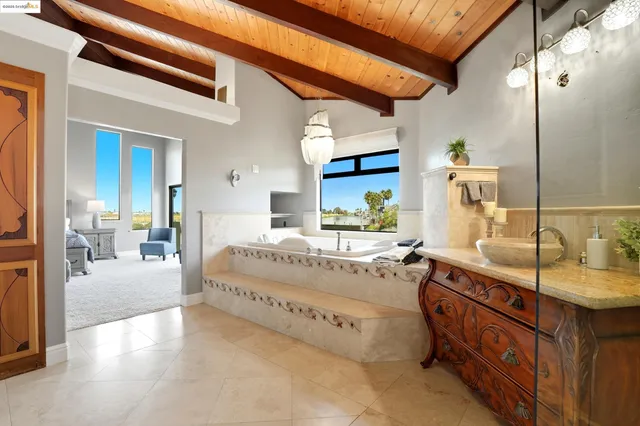 a spacious bedroom with a large bed and a dresser