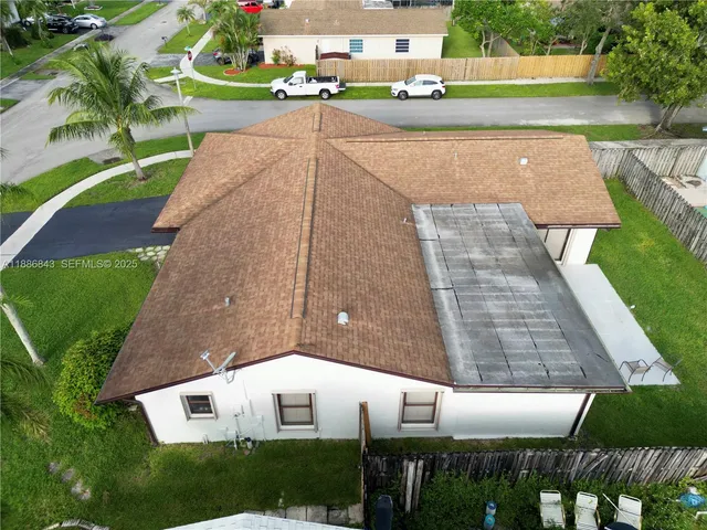 an aerial view of a house with a yard