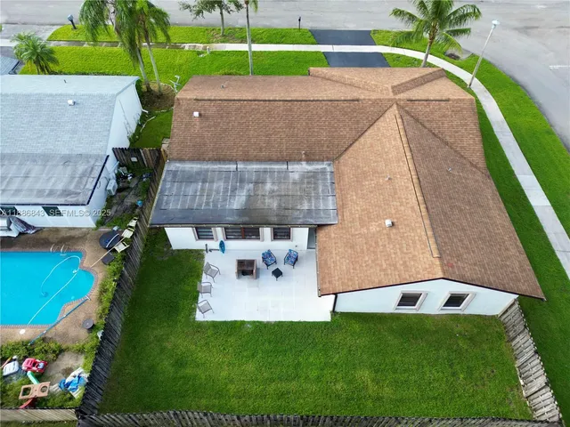 a backyard of a house with outdoor seating and entertaining space