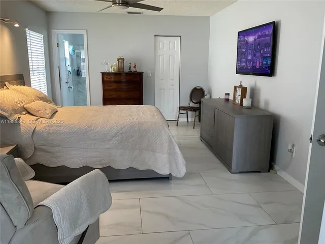 a bedroom with a bed and a mirror