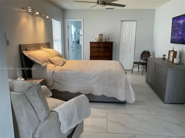 a bed room with a bed and a chair