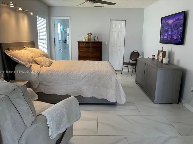 a bathroom with a granite countertop sink a toilet and shower