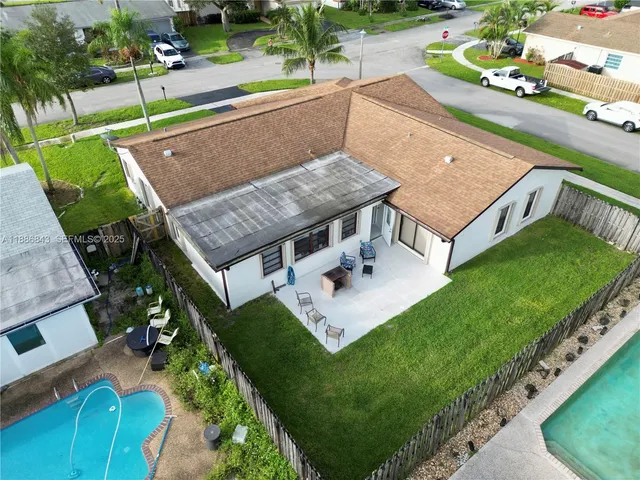 an aerial view of a house with a yard