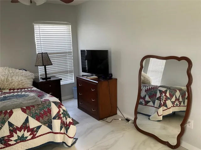 a bed room with a bed and a television