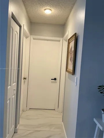 a bathroom with a sink mirror and toilet