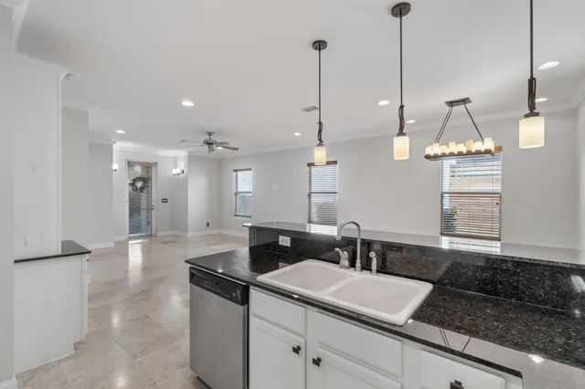 a view of a kitchen with a sink and chandelier