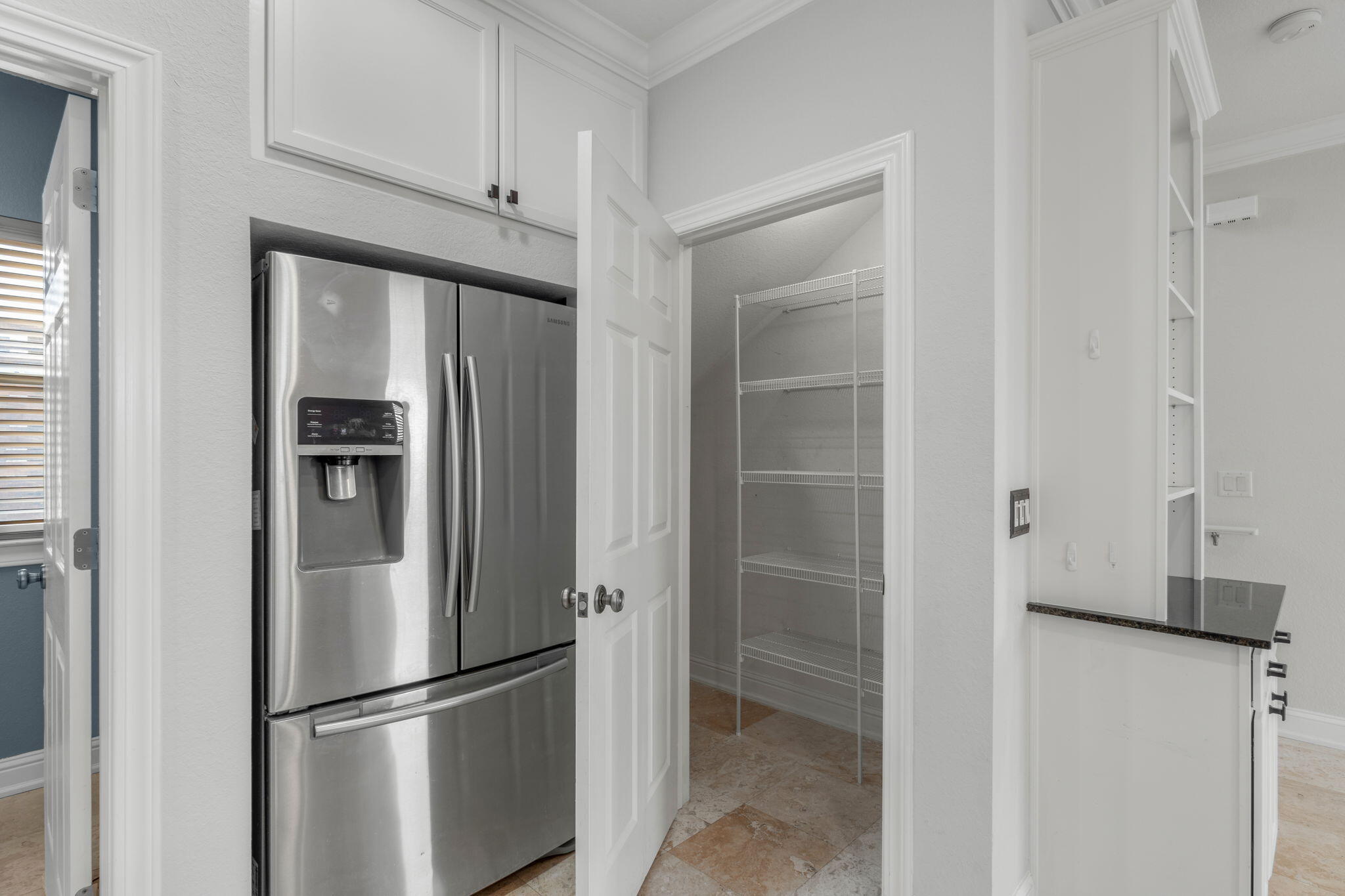 4739 Amhurst Circle Destin, FL 32541 - Photo 13 of 37 a view of a refrigerator in kitchen and an empty room