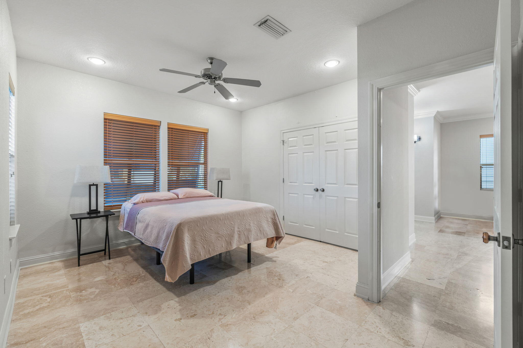 4739 Amhurst Circle Destin, FL 32541 - Photo 16 of 37 a spacious bedroom with a bed and a chandelier