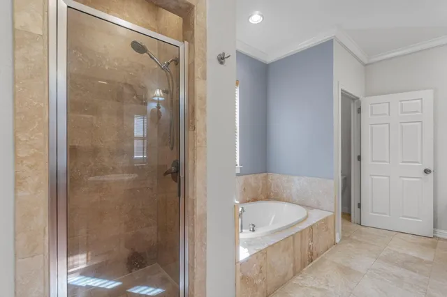 a bathroom with a tub shower and vanity