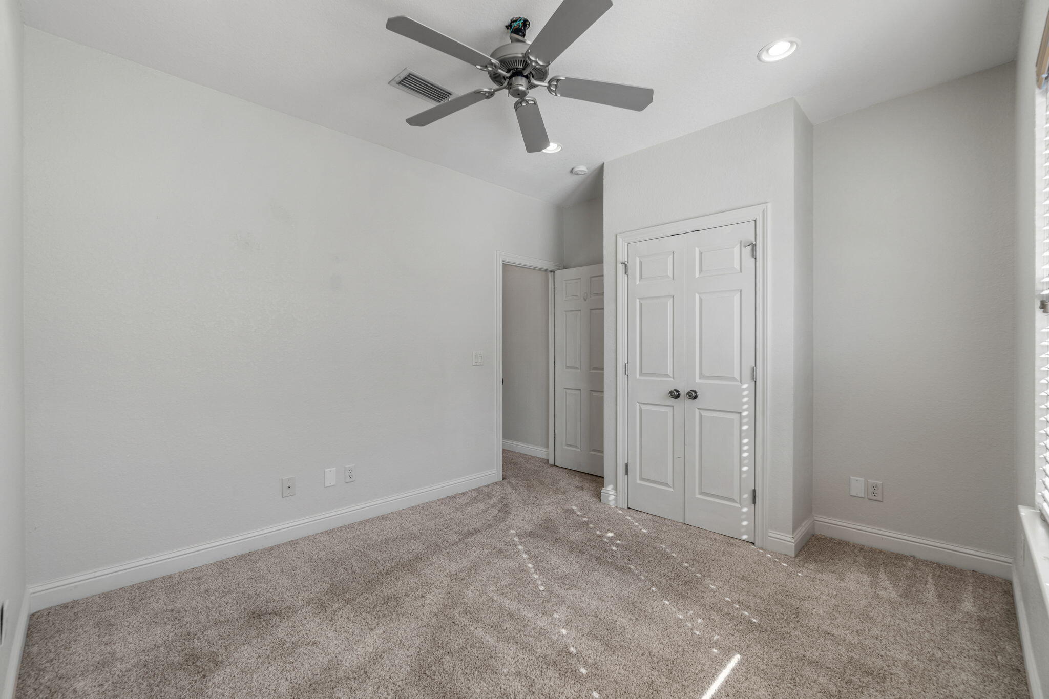 4739 Amhurst Circle Destin, FL 32541 - Photo 26 of 37 an empty room with closet and a ceiling fan