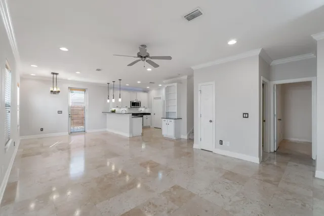 a view of a kitchen with a refrigerator and a sink