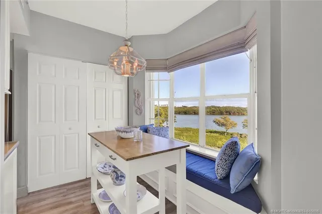 a living room with furniture and floor to ceiling windows