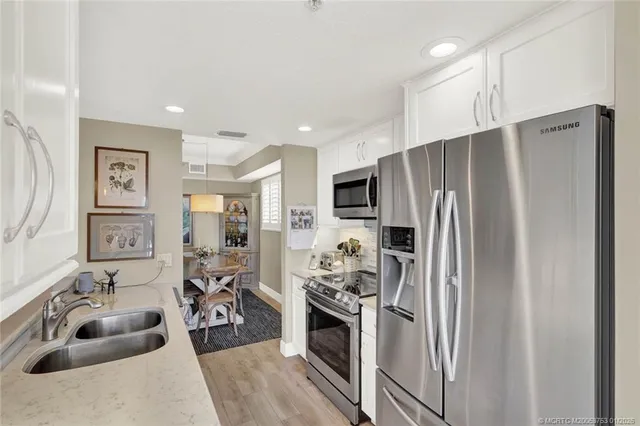 a bedroom with two beds and a large window