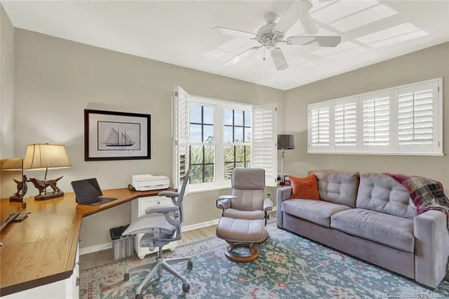 a view of a swimming pool with a lounge chair and palm trees