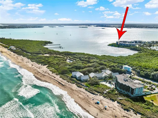 a view of a city with lots of residential buildings ocean and mountain view in back