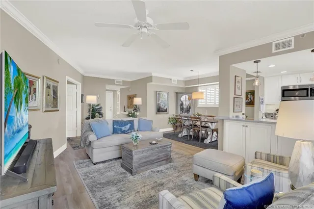 a dining room with wooden floor and a chandelier