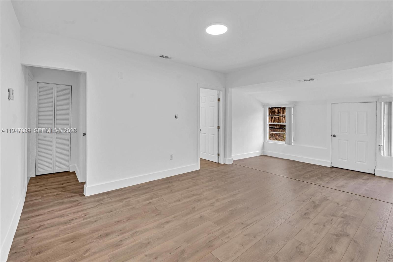 2636 Southwest 29th Court Miami, FL 33133 - Photo 11 of 33 a view of an empty room with wooden floor